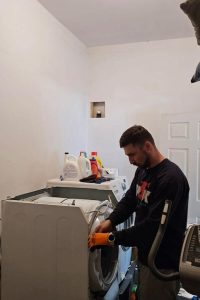 dryer repair specialists opening up the dryer