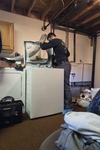 technician checking dryer vent during repairs