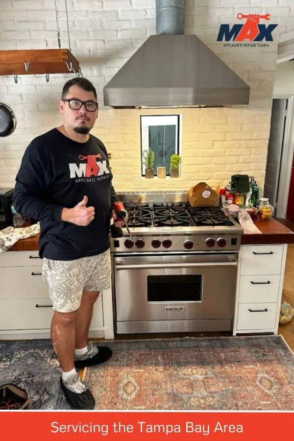 Max Appliance Repair Tampa technician beside a gas kitchen range