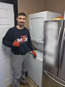Max Appliance Repair technician beside the reassembled GE laundry center