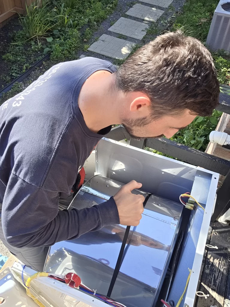 Technician working inside an opened Samsung dryer cabinet
