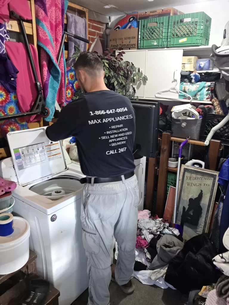 Technician opening the top of an Amana washer during drum support repair